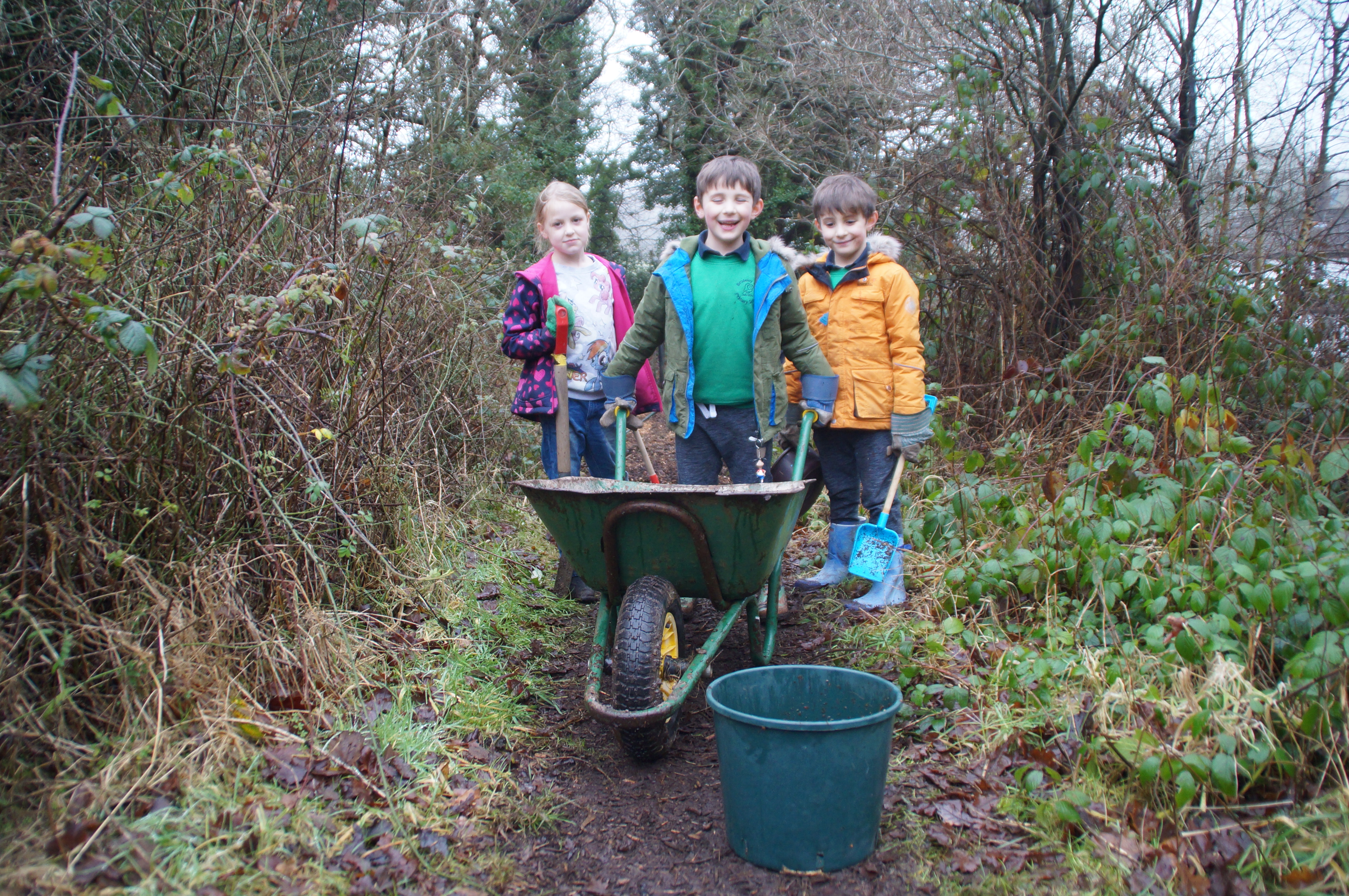 Broseley CE School children barrowing wood chippings 