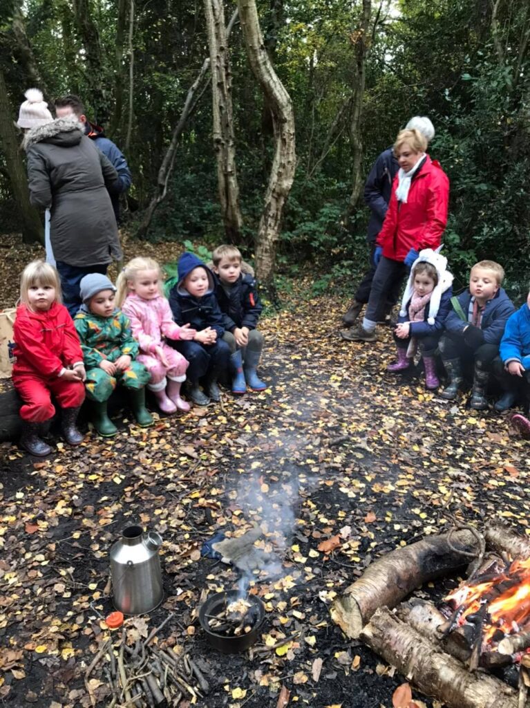 The children sitting around the fire