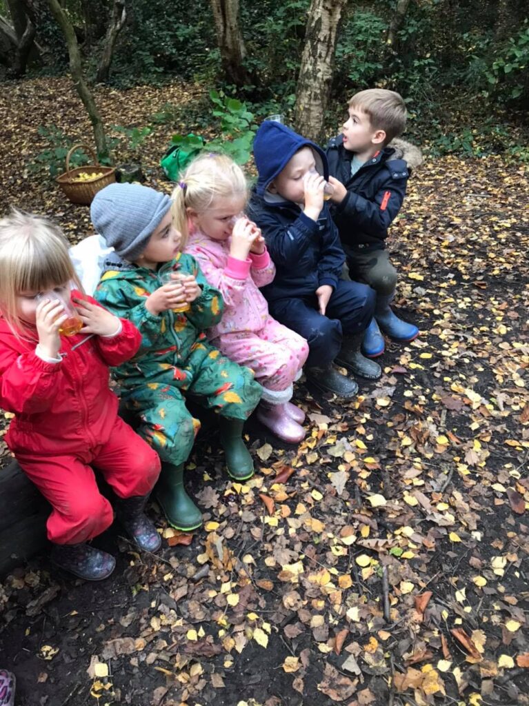 The children enjoy a drink of apple juice